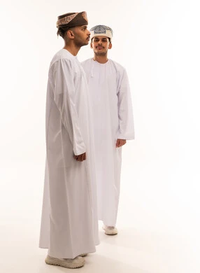Omani Men in Traditional Dishdasha and Kumma