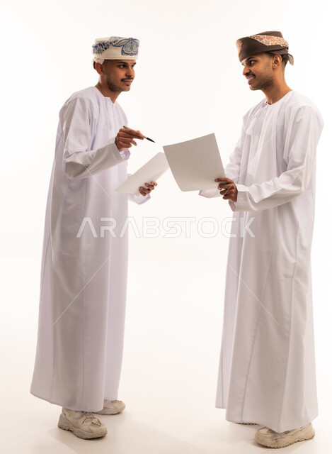 Omani Men Discussing Business Documents on White Background