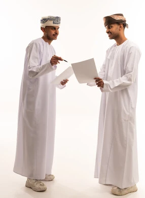 Omani Men Discussing Business Documents on White Background