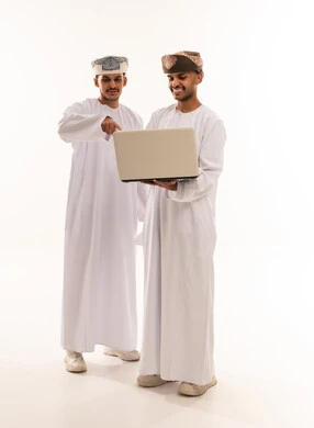 Omani Men Using Laptop in Traditional Clothing