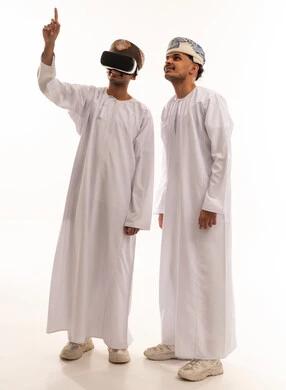 Omani Men Using VR Headset in Traditional Clothing
