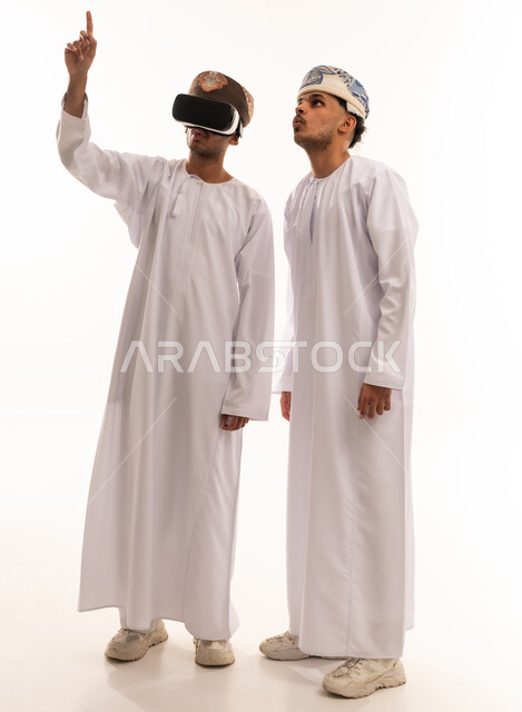 Omani Men Using VR Headset in Traditional Dress