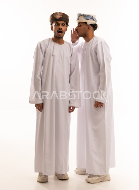 Omani Men Whispering Secret with Shocked Expression