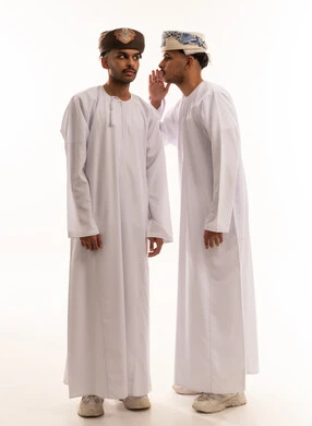 Omani Men Whispering Secret in Traditional Attire