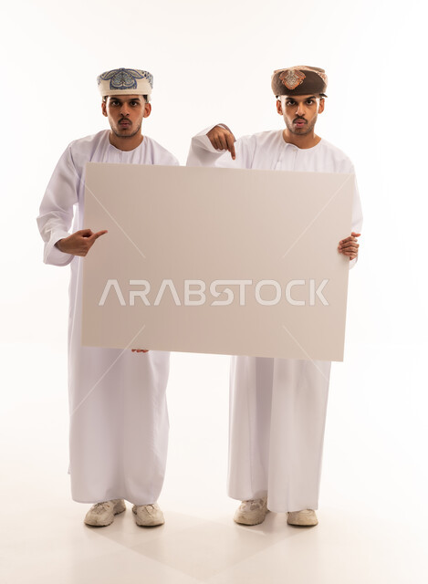 Omani Men in Traditional Dishdasha Holding Blank Board