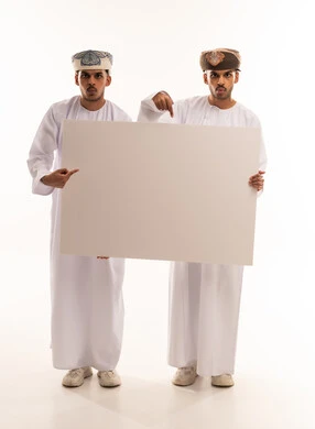 Omani Men in Traditional Dishdasha Holding Blank Board