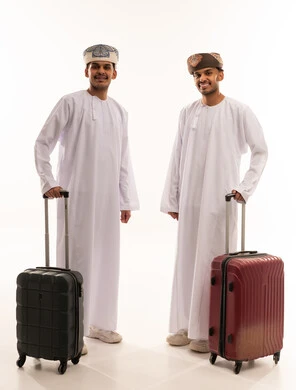 Omani Men in Traditional Dress with Travel Luggage