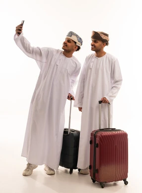 Omani Men Travelers with Suitcases Taking Selfie