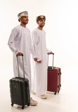 Omani Men in Traditional Dress with Suitcases