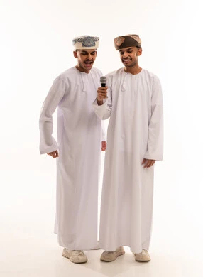 Omani Men in Traditional Dress Singing with Microphone