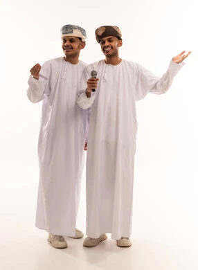 رجال عمانيون بالزي التقليدي مع ميكروفون