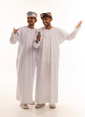 Omani Men in Traditional Dress Holding Microphone