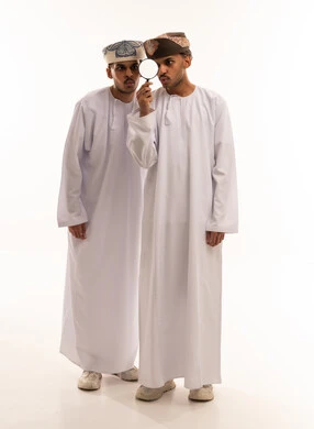 Omani Men Investigating With Magnifying Glass