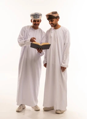 Omani Men in Traditional Dress Reading a Book