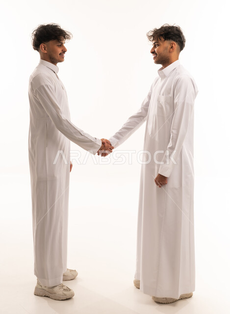 Saudi Men in Thobes Shaking Hands on White Background
