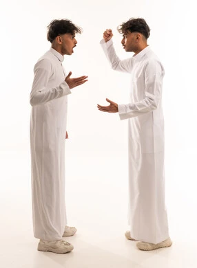 Two Saudi Men Arguing in Traditional White Thobes