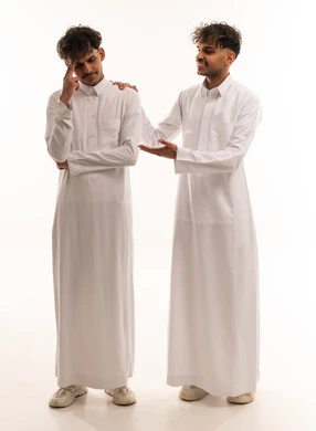 Saudi Men in Traditional Thobes Supporting Stressed Friend