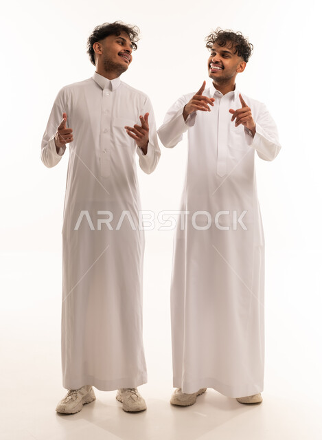 Two Saudi Men in Traditional White Thobes Gesturing