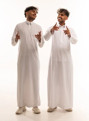 Two Saudi Men in Traditional White Thobes Gesturing