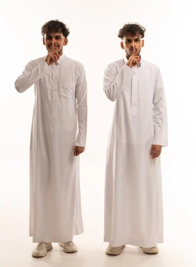 Saudi Men in White Thobes Making Silence Gesture