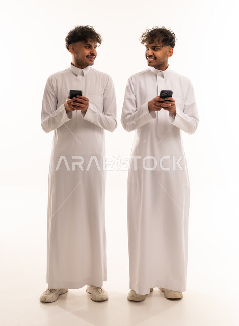 Saudi Men in Thobes with Smartphones in Studio