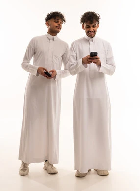 Saudi Men in Traditional Thobes Using Smartphones