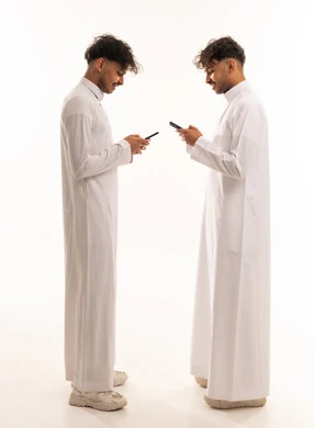 Saudi Men in Traditional Thobe Using Smartphones