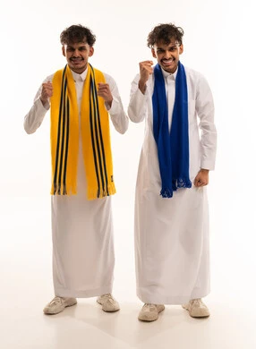 Saudi Football Fans Cheering in Traditional White Thobe