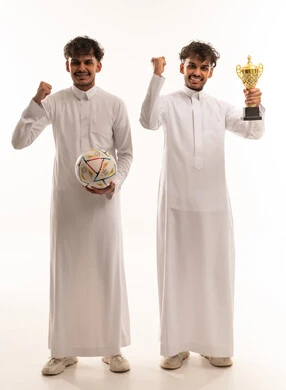 Saudi Men Celebrating Sports Victory with Trophy