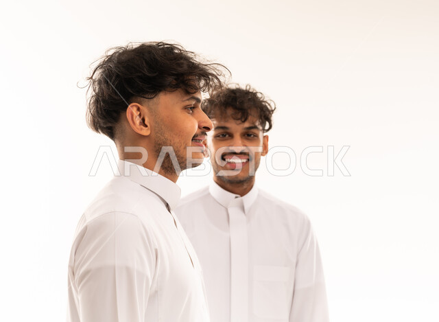 Two Saudi Men in Traditional Thobes on White Background