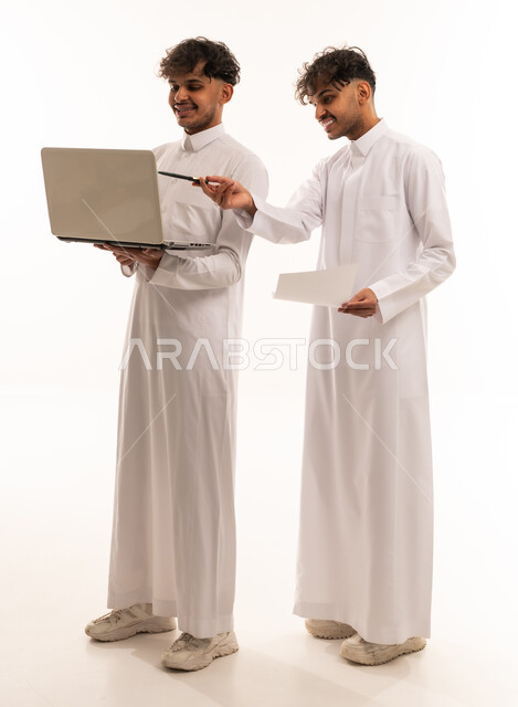 Saudi Men Working on Laptop Over White Background