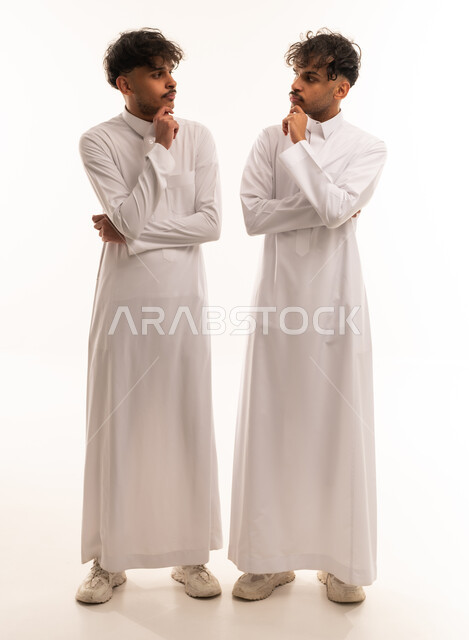Saudi Men in Traditional Thobes Thinking in Studio