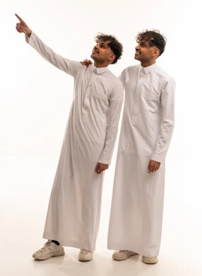 Two Saudi Men in Traditional Thobes Pointing Upward