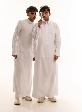 Saudi Men in Traditional Thobes with Magnifying Glass