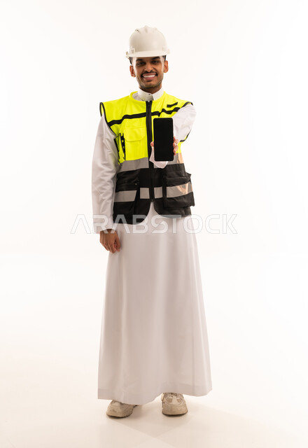 Saudi Engineer in Safety Vest Holding Smartphone
