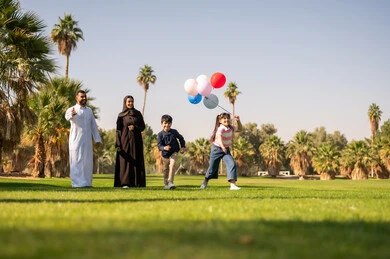 Arab Family Playing with Balloons in Sunny Park Arab Family Playing with Balloons in Sunny Park