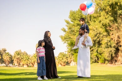 Saudi Family in Park with Balloons and Traditional Dress
