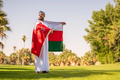 Omani Man with National Flag in Public Park