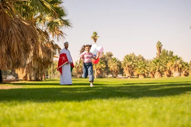 Omani Man and Girl Celebrating with National Flag