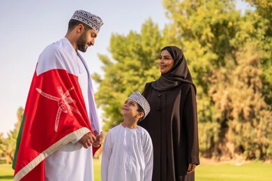 Omani Family with National Flag in Park