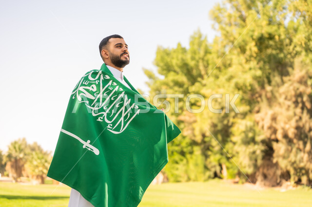 Saudi Man with National Flag in Outdoor Park