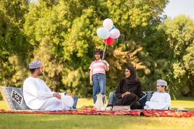 Omani Family Picnic in Park with Balloons