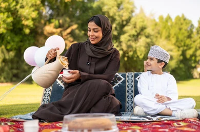 Omani Woman and Child Having Picnic in Park