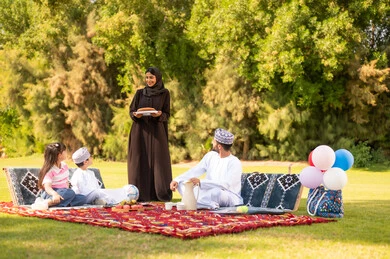 Omani Family Picnic in Park Wearing National Dress