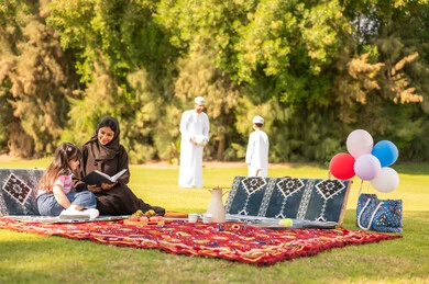 Omani Family Picnic in Green Park with Traditional Clothing