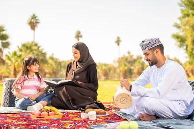 Omani Family Picnic in Park with Traditional Dress