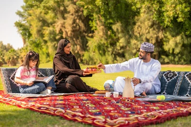 Omani Family Picnic in Park with Traditional Dress Omani Family Picnic in Park with Traditional Dress