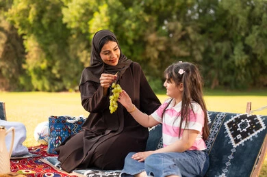Arab Mother and Daughter Having Picnic in Sunny Park