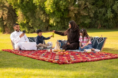 Saudi Family Picnic in Green Park with Traditional Attire