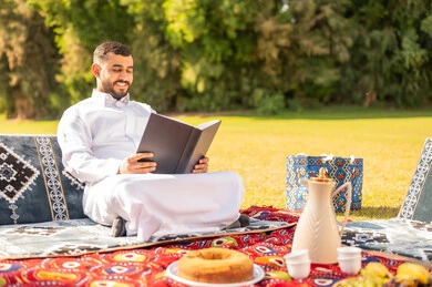Saudi Man Reading Book in Green Park Picnic Saudi Man Reading Book in Green Park Picnic